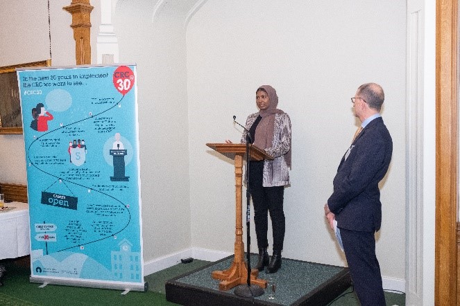 Fowiza and Siham speaking at a lectern