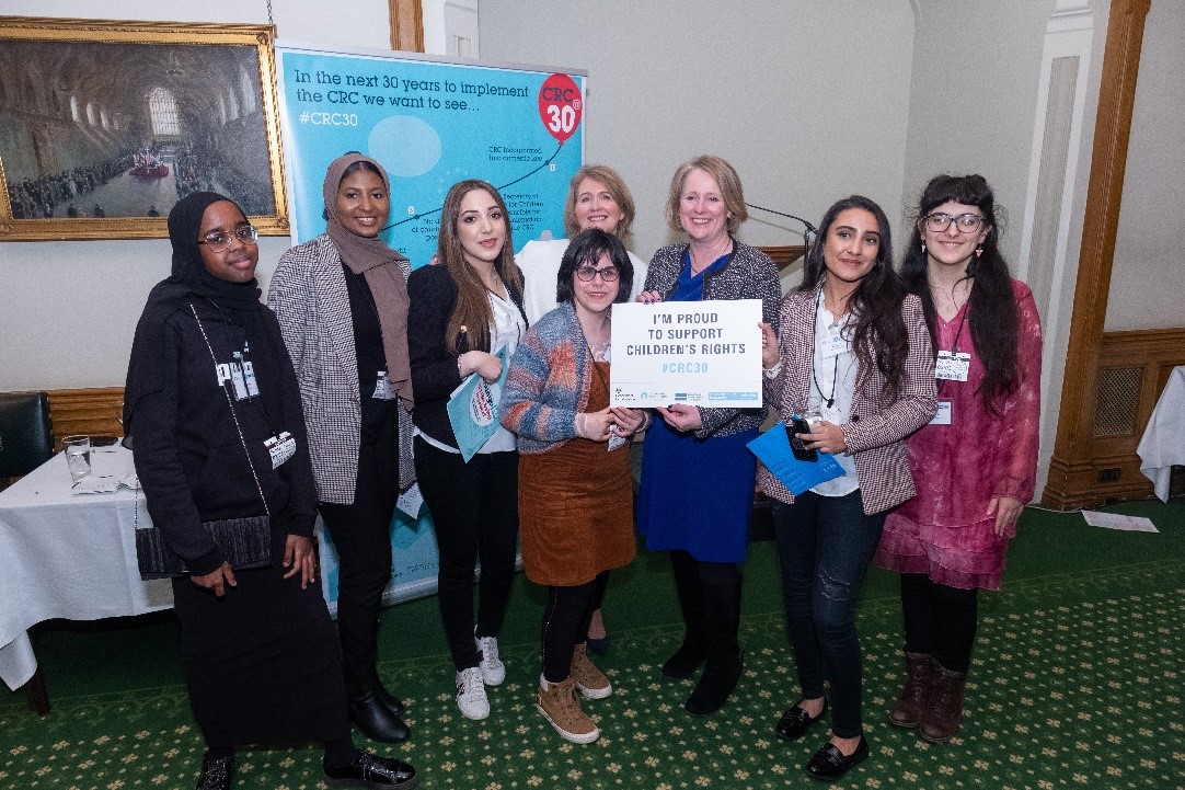 Group of campaigners holding card reading 'I'm proud to support children's rights'